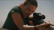 Johansson shoots at a sea-borne predator (Image via YouTube/ Universal Pictures)